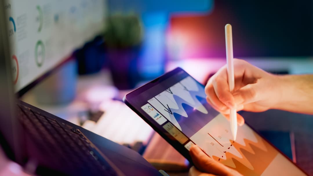 Professional reviewing data analytics on a tablet
